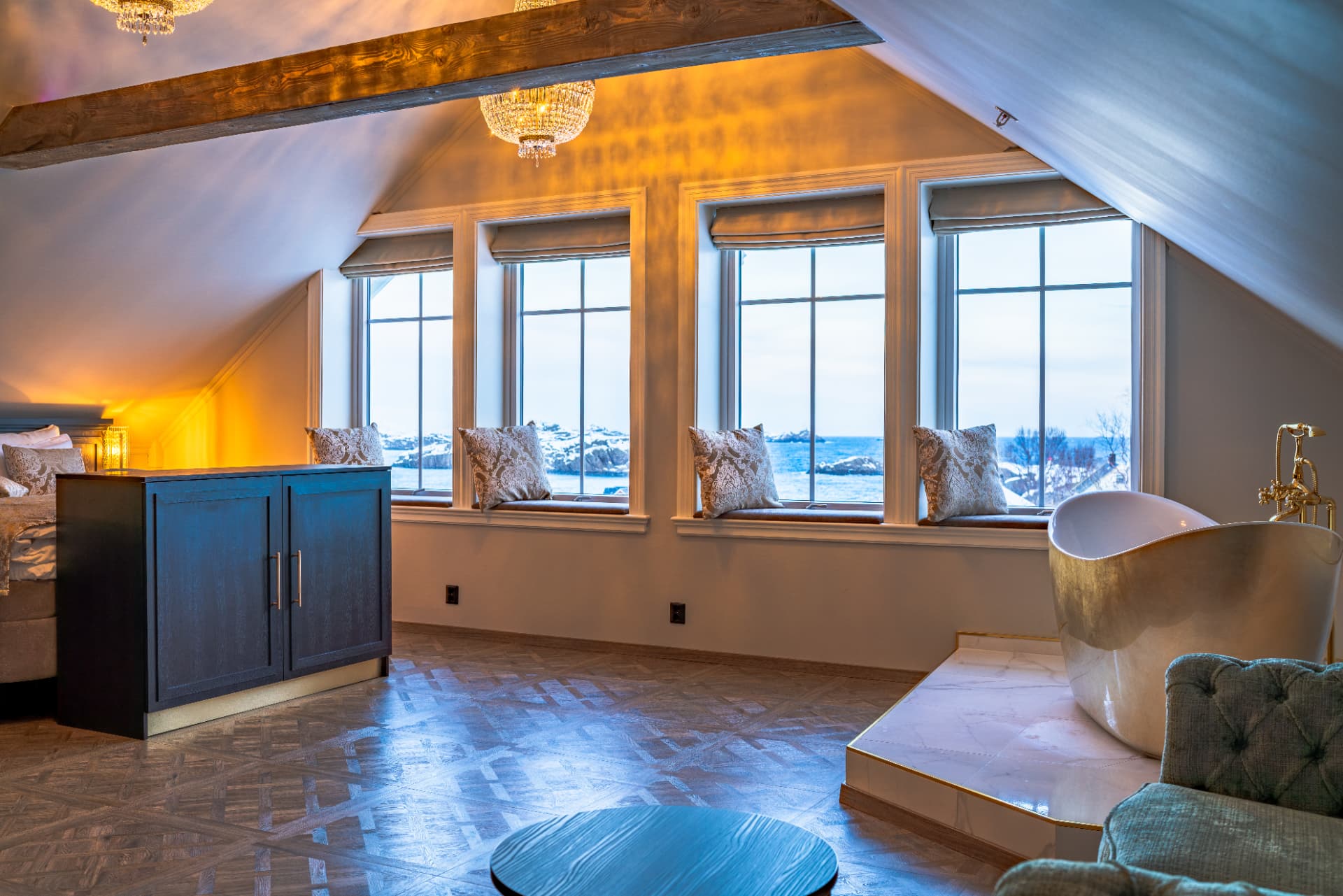 URE suite — four tall windows framing snow-covered islands and the winter sea